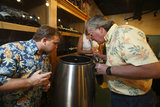 Potential clients looking at a WinePod unit during a demonstration at the Joseph George Wine Shop  in San Jose, CA, on September 4, 2008.The WinePod is the world's first personal winemaking system that allows anyone to make wine at home with no experience required.   The WinePod is made and distributed by Provina, inc.